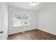 Well-lit bedroom features hardwood flooring, neutral walls, and a window for natural light at 1345 Sw Dodson Dr, Atlanta, GA 30311