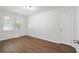 Bright bedroom with neutral walls, hardwood floors, and natural light from a large window at 1345 Sw Dodson Dr, Atlanta, GA 30311