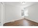 Bright bedroom boasts hardwood floors, a ceiling light, and a window at 1345 Sw Dodson Dr, Atlanta, GA 30311