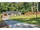 Charming ranch-style home featuring a spacious front yard, updated windows, and a welcoming wood deck at 1345 Sw Dodson Dr, Atlanta, GA 30311