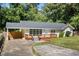 Inviting ranch-style home with updated windows, a brick facade, and a cozy, elevated wood deck at 1345 Sw Dodson Dr, Atlanta, GA 30311