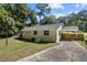 Cozy single-story home featuring a carport and a concrete driveway surrounded by a lush lawn at 1345 Sw Dodson Dr, Atlanta, GA 30311
