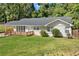Charming ranch-style home with a brick facade, updated windows, and a quaint wood deck in front at 1345 Sw Dodson Dr, Atlanta, GA 30311