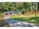 Charming ranch-style home featuring a spacious front yard, updated windows, and a welcoming wood deck at 1345 Sw Dodson Dr, Atlanta, GA 30311