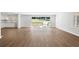 Open-concept living area featuring wood flooring, large windows, and access to a porch at 1345 Sw Dodson Dr, Atlanta, GA 30311