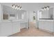 Well-lit bathroom with and sinks, white cabinetry, ceramic tile, and an entrance to the main bedroom at 1692 Holcomb Lake Rd, Marietta, GA 30062