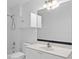 Bright bathroom features a modern vanity, large mirror, and a tub/shower with white tile surround at 1692 Holcomb Lake Rd, Marietta, GA 30062
