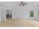 Spacious bedroom boasts tray ceilings, a ceiling fan, and sun-filled windows overlooking the backyard at 1692 Holcomb Lake Rd, Marietta, GA 30062