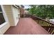 Large deck with brown wood offers views of the backyard, neighborhood, and community pond at 1692 Holcomb Lake Rd, Marietta, GA 30062
