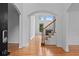 Bright foyer showcasing hardwood floors, a staircase, and an arched entryway at 1692 Holcomb Lake Rd, Marietta, GA 30062