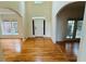 Spacious foyer with gleaming hardwood floors, archways, and a bright entry door at 1692 Holcomb Lake Rd, Marietta, GA 30062