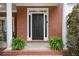Charming front door entrance with brick facade, columns and lush greenery, creating a welcoming curb appeal at 1692 Holcomb Lake Rd, Marietta, GA 30062
