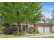 Charming brick home with manicured landscaping, a welcoming front porch, and a two-car garage at 1692 Holcomb Lake Rd, Marietta, GA 30062