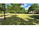Expansive green space featuring mature trees, walking path, and picnic tables, perfect for outdoor activities at 1692 Holcomb Lake Rd, Marietta, GA 30062