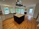 Open kitchen with a large center island, fireplace, and tons of natural light at 1692 Holcomb Lake Rd, Marietta, GA 30062