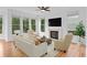 Elegant living room featuring a fireplace, hardwood floors, and plenty of natural light at 1692 Holcomb Lake Rd, Marietta, GA 30062