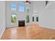 Sunlit living room boasts high ceilings, hardwood floors, and a cozy fireplace at 1692 Holcomb Lake Rd, Marietta, GA 30062