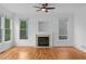Bright living room features hardwood floors, a fireplace, and large windows at 1692 Holcomb Lake Rd, Marietta, GA 30062