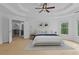 Main bedroom with tray ceiling, ceiling fan, carpet, and access to ensuite and upstairs hallway at 1692 Holcomb Lake Rd, Marietta, GA 30062