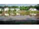 Scenic pond view with a rainbow, surrounded by lush green trees and beautiful houses at 1692 Holcomb Lake Rd, Marietta, GA 30062