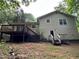 A two-story home with a wooden deck and a small backyard with mature trees at 2756 Del Ridge Dr, Douglasville, GA 30135