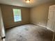 Standard bedroom with neutral walls, carpet, and a large window for natural light at 2756 Del Ridge Dr, Douglasville, GA 30135