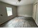 An empty bedroom featuring neutral walls, a window for natural light, and a standard ceiling light at 2756 Del Ridge Dr, Douglasville, GA 30135