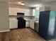 Well-lit kitchen with white cabinets, modern appliances, and durable wood flooring at 2756 Del Ridge Dr, Douglasville, GA 30135