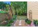 Landscaped backyard featuring stone pathway and an iron decorative piece at 2978 Legislative Ln, Buford, GA 30519