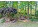 Backyard deck sitting area with seating nestled among mature trees provides a private outdoor retreat at 2978 Legislative Ln, Buford, GA 30519
