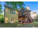 Backyard view of home, featuring an elevated screened porch, stairs, and patio at 2978 Legislative Ln, Buford, GA 30519