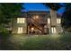 Backyard view of the house highlighting the screened-in porch, deck, and manicured lawn at 2978 Legislative Ln, Buford, GA 30519