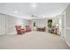 Finished basement area featuring neutral paint, seating, an exterior door, and a ceiling fan at 2978 Legislative Ln, Buford, GA 30519