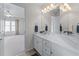 Clean bathroom featuring a long vanity with a large mirror and a separate shower and toilet at 2978 Legislative Ln, Buford, GA 30519