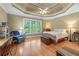 A serene bedroom featuring hardwood floors, a cozy armchair, and large window for natural light at 2978 Legislative Ln, Buford, GA 30519