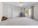 A cozy, carpeted bedroom featuring a rocking chair and a teddy bear next to the door at 2978 Legislative Ln, Buford, GA 30519