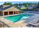 Resort style community pool with sun loungers and seating area, next to clubhouse and tennis court at 2978 Legislative Ln, Buford, GA 30519