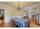 Traditional dining room featuring hardwood floors, chandelier lighting, and elegant wainscoting details at 2978 Legislative Ln, Buford, GA 30519