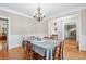 Traditional dining room with hardwood floors, crown molding and view into the living space at 2978 Legislative Ln, Buford, GA 30519
