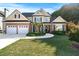 Charming two-story home with a well-manicured lawn, brick accents, and a two-car garage at 2978 Legislative Ln, Buford, GA 30519