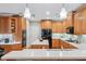 Well-equipped kitchen featuring wood cabinets, white countertops, stainless steel appliances, and center island at 2978 Legislative Ln, Buford, GA 30519