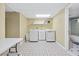 Bright laundry room features a front-loading washer, dryer, utility sink, and ample storage space at 2978 Legislative Ln, Buford, GA 30519