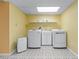 Laundry room featuring front load washer and dryer, utility sink, and storage shelf at 2978 Legislative Ln, Buford, GA 30519