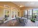 Cozy screened porch offering a dining area and comfortable seating for enjoying the outdoors at 2978 Legislative Ln, Buford, GA 30519