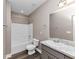 Bathroom with a single vanity, tub with shower, and modern flooring at 6755 Biscayne Blvd, Rex, GA 30273