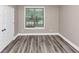 Empty bedroom featuring modern flooring, natural light from a window and a closet at 6755 Biscayne Blvd, Rex, GA 30273