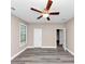 Spacious bedroom featuring a ceiling fan, natural light from the window, and modern flooring at 6755 Biscayne Blvd, Rex, GA 30273