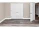 Neutral bedroom with gray floors, open closet, and window with white trim at 6755 Biscayne Blvd, Rex, GA 30273