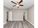 Spacious bedroom featuring a ceiling fan, modern flooring, and access to an ensuite bathroom at 6755 Biscayne Blvd, Rex, GA 30273