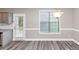Dining room with modern flooring, neutral paint, natural light and an access door to the back at 6755 Biscayne Blvd, Rex, GA 30273